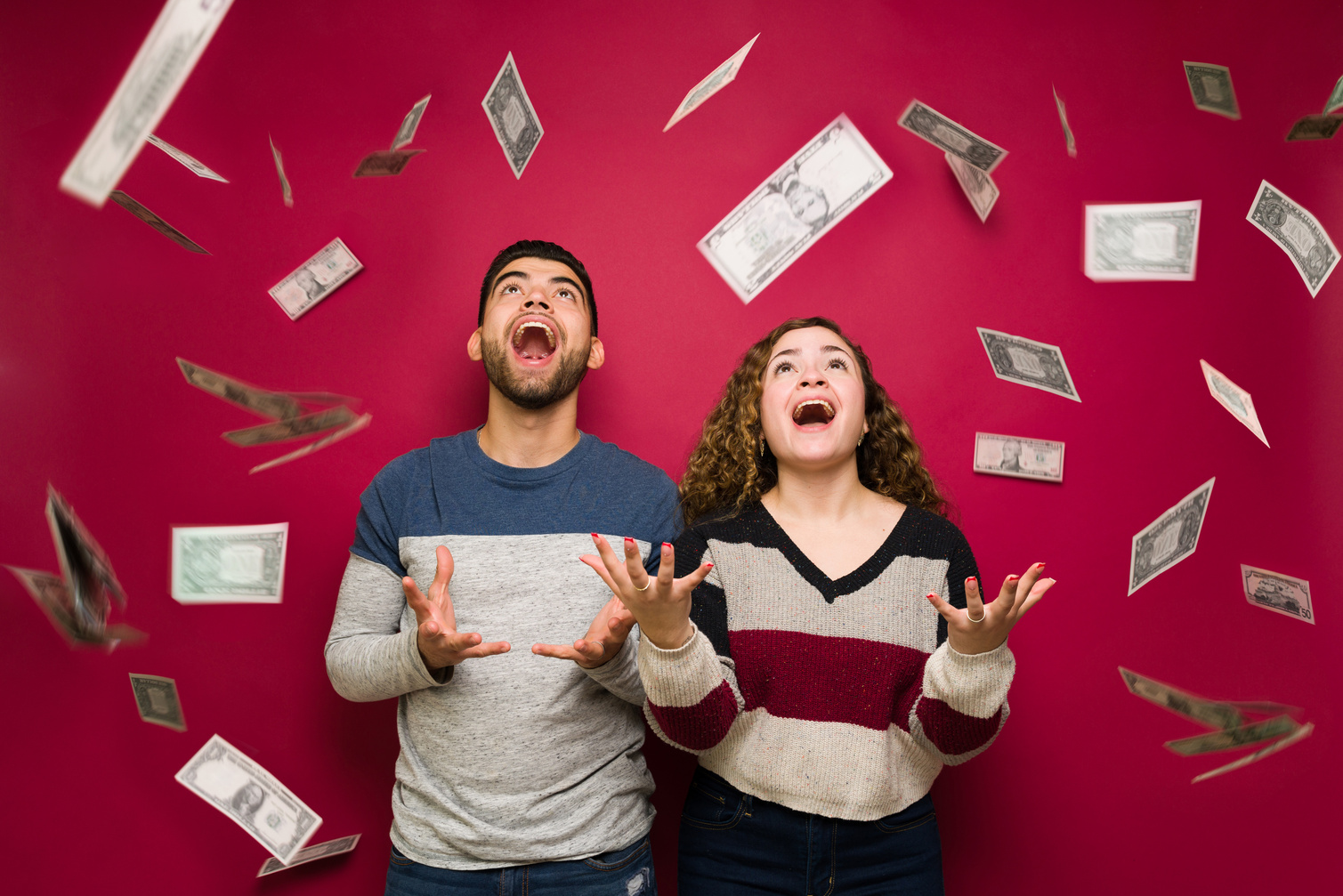 Excited couple with a lot of money